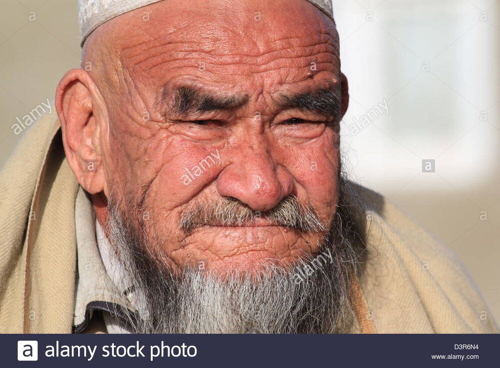 An old man sits on a wall in kabul his lined face shows advanced years D3R6N4