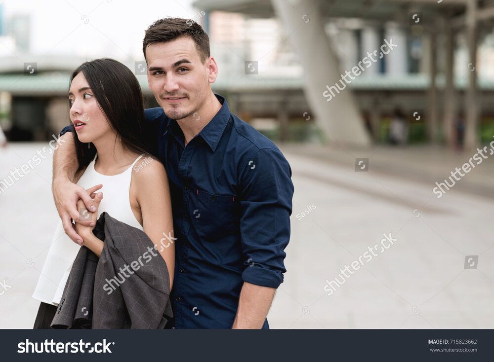 Stock photo happy young interracial couple happy handsome young white male holding a young bea