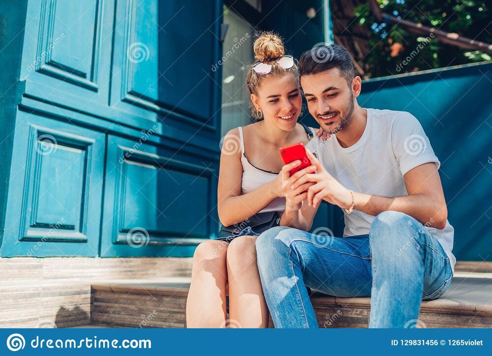 Mixed race couple love walking city arab men white women drinking coffee using smartphone outd