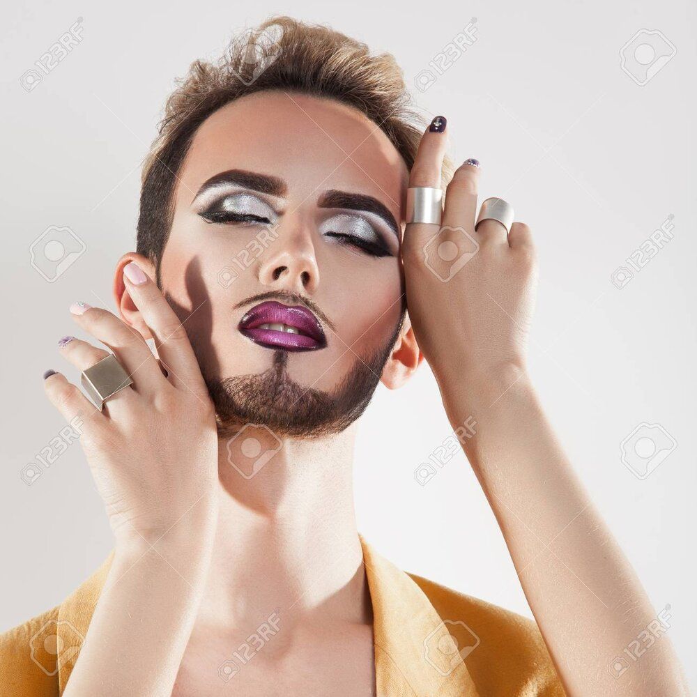 43404803 sensual man with makeup and closed eyes in studio grey background square 