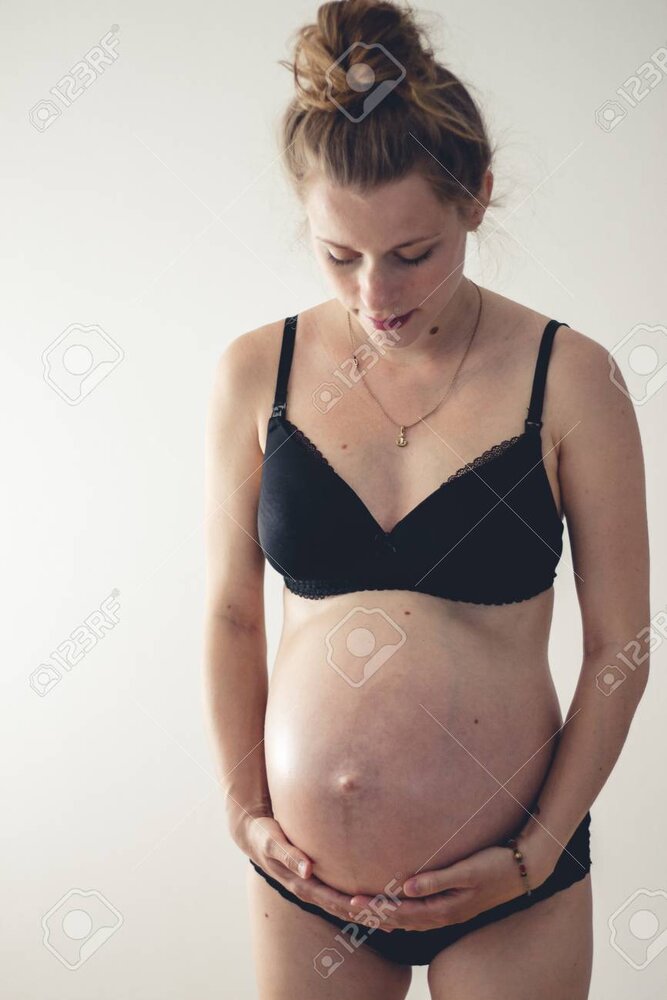 101009236 standing woman with big pregnant belly