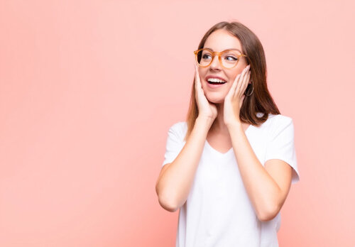 young-red-head-woman-feeling-happy-excited-surprised-looking-side-with-both-hands-face-against...jpg