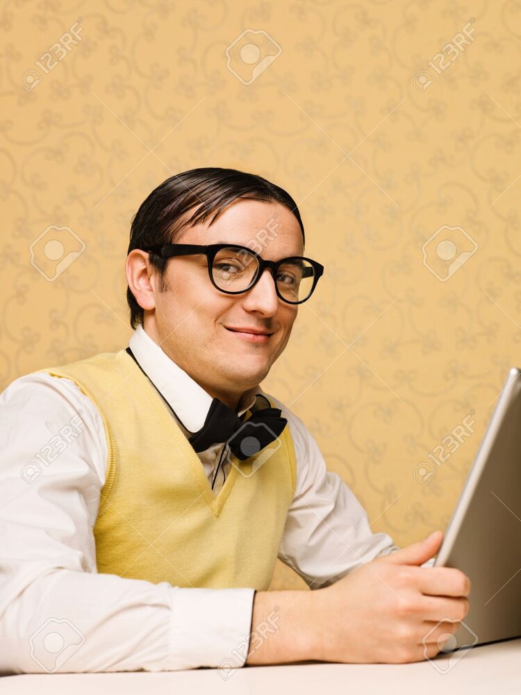 36442469 young nerd sitting at the computer 36442469 young nerd sitting at the computer