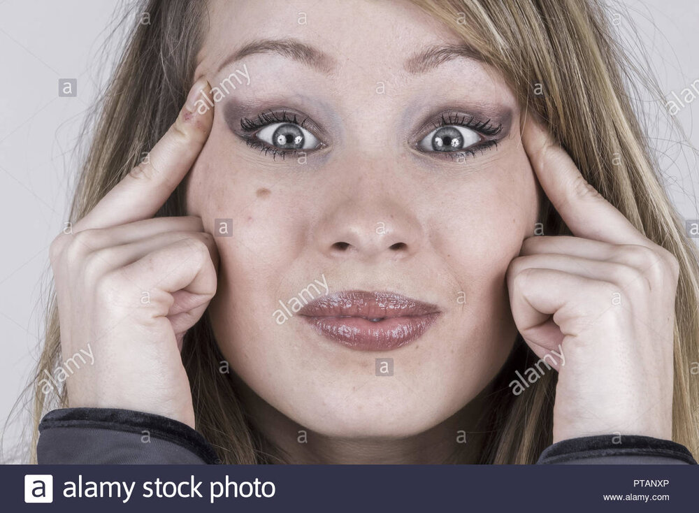 Young woman pulling her eyes aside model released PTANXP