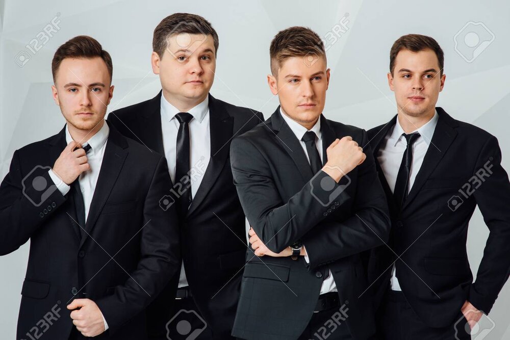 94528095 group of four men in suits white background