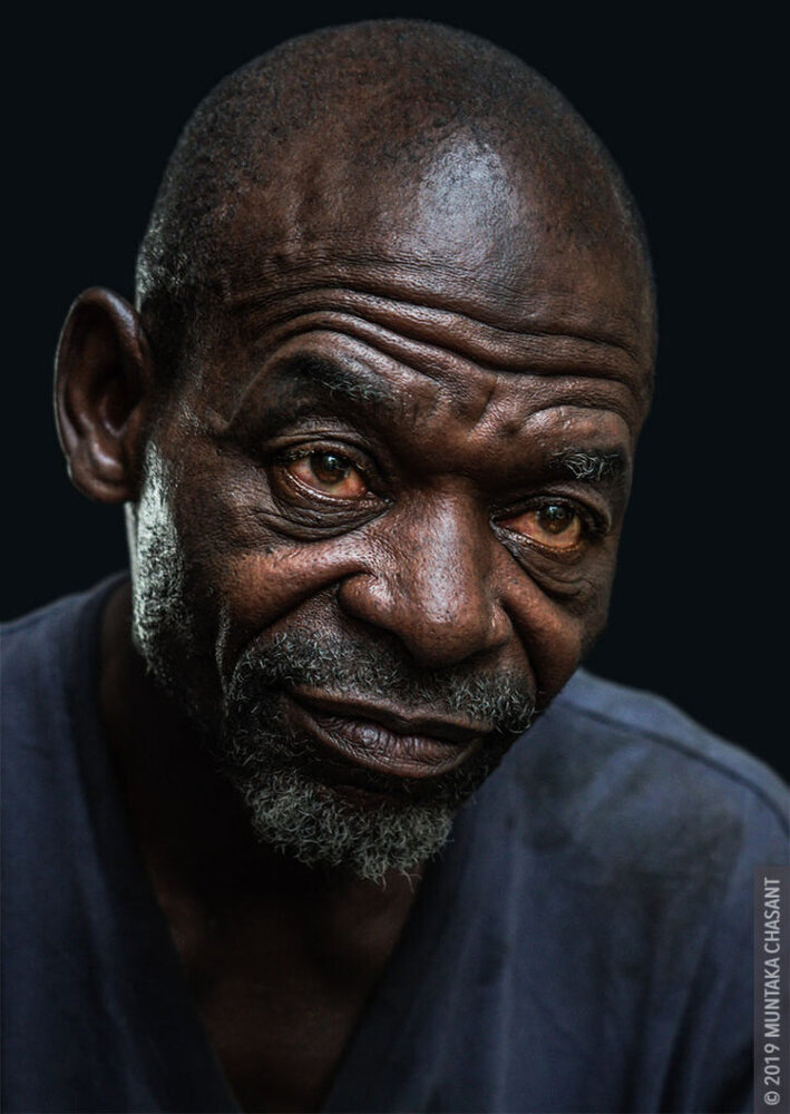 African Man Thinking Photo by Muntaka Chasant