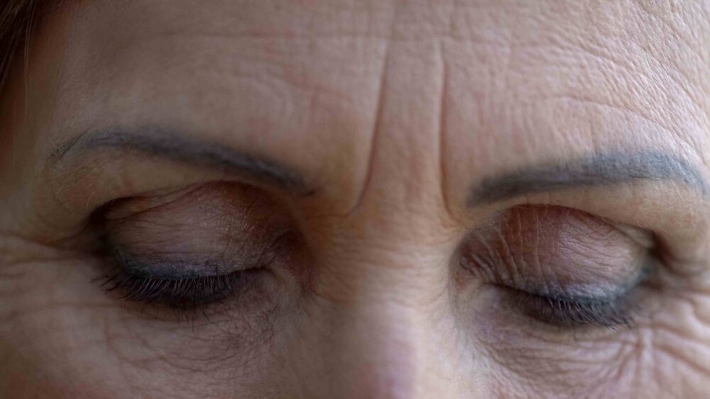 Closed eyes of wrinkled old woman  eyebrows and eyelids tattoo  beauty concept 1127407058 cdd6