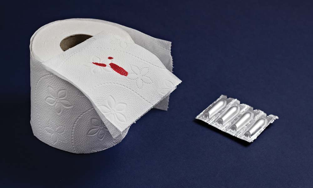 Toilet paper with blood on sqare and suppositories