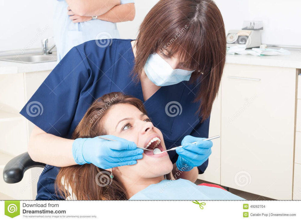 Oral hygienist work orthodontist female patient beautiful teeth 49262704