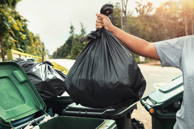 Woman hand holding garbage black bag cleaning trash 34152 1926
