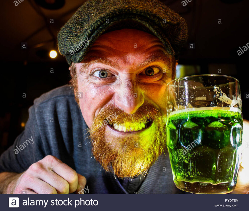 Crazy irish guy drinks green beer during celebration of st patricks day or night RYDTEM
