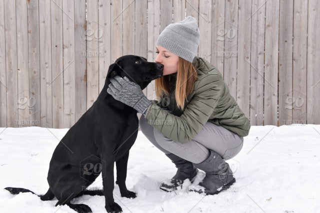 Stock photo outdoors snow dog love girl pet woman kiss millennial 64912130 f826 4850 8531 6618