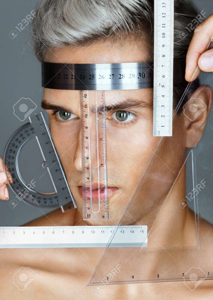 64945753 perfect face proportions portrait of an attractive man with measuring rulers plastic 
