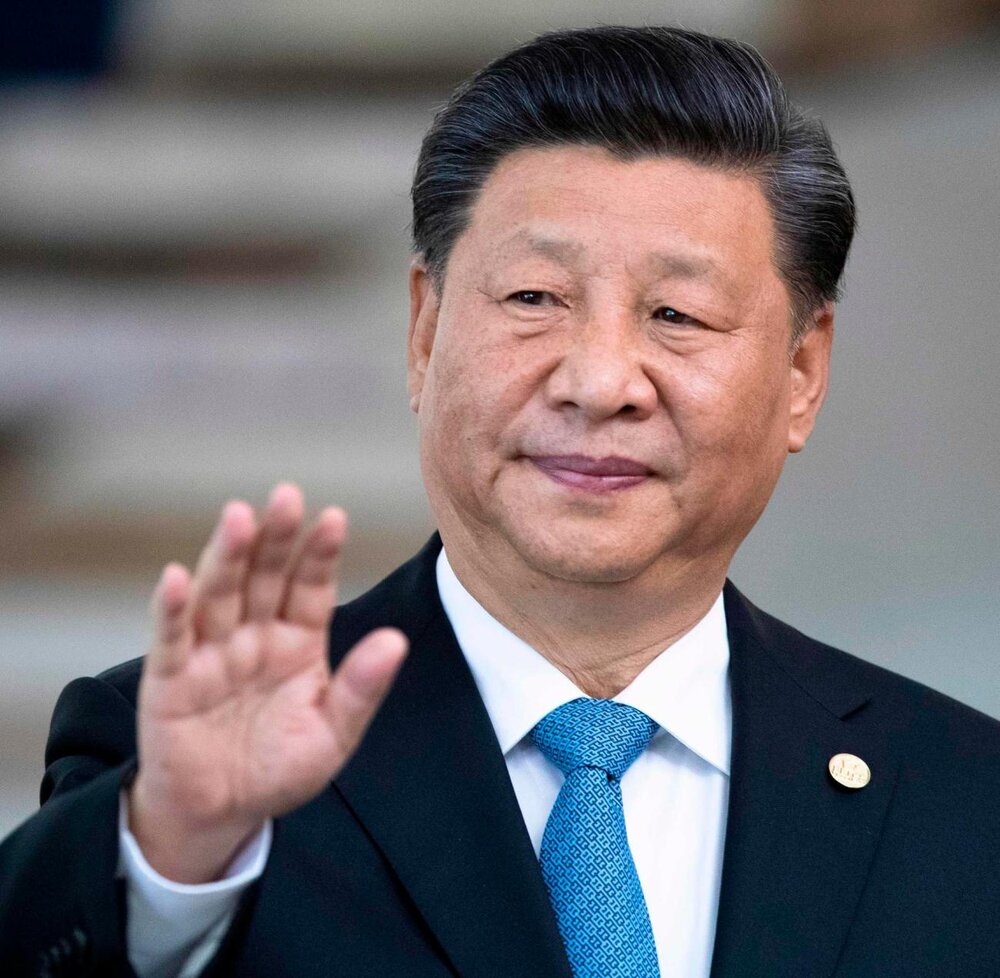 China s President Xi Jinping waves