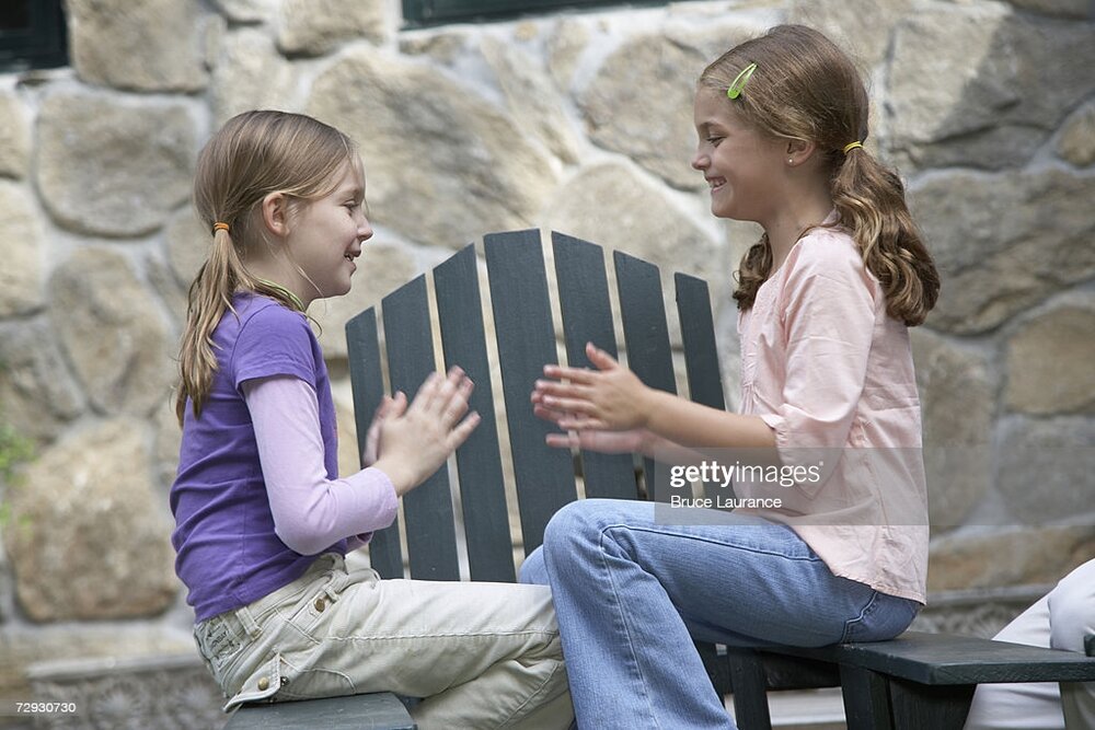 Girls playing pattycake smiling side view picture id72930730