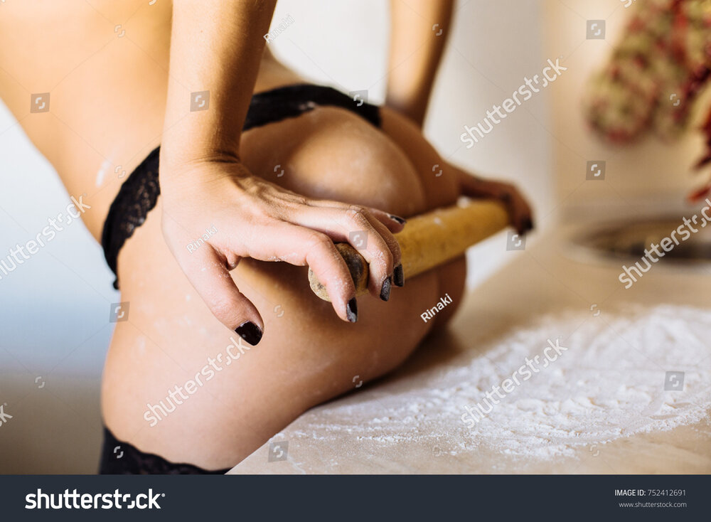 Stock photo beautiful young girl in the kitchen in flour a separate part of the body ass 75241