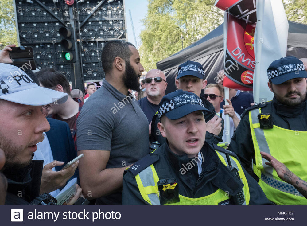 Mohammed hijab is removed by police for his own protection during the day for freedom event in