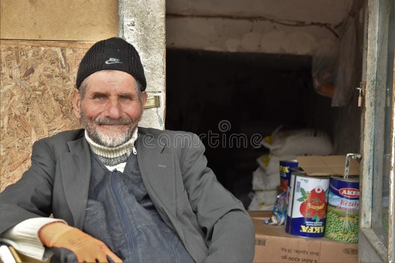 Portrait turkish anatolian shopkeeper man blue eyes february ankara turkey wearing branded hat