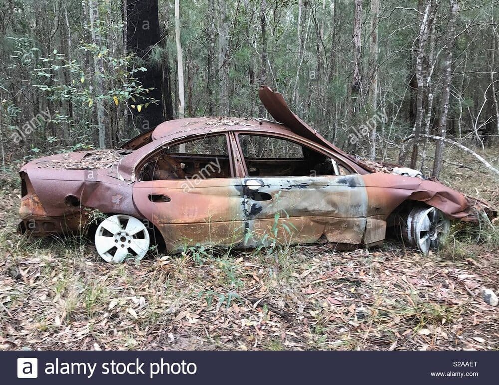 A burnt out and rusty car located in the mororo state forest nsw australia grim times we live 