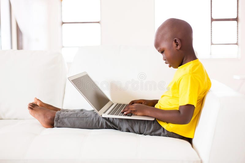Little black boy laptop side view cute using home 63088569
