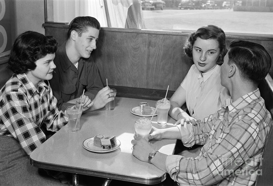 Teen couples at a diner c1950s h armstrong robertsclassicstock