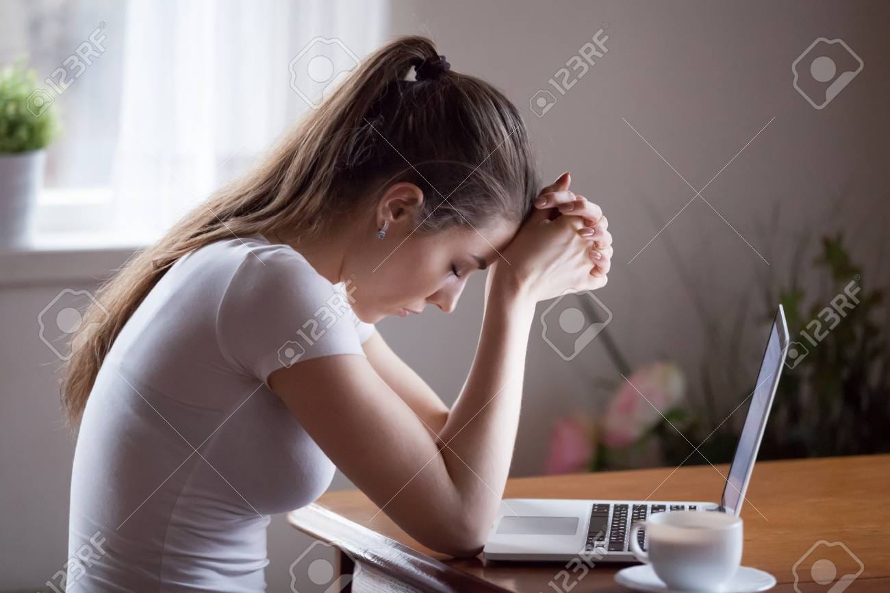107735249 sad young woman sit at laptop broken after reading bad news online upset girlfriend 