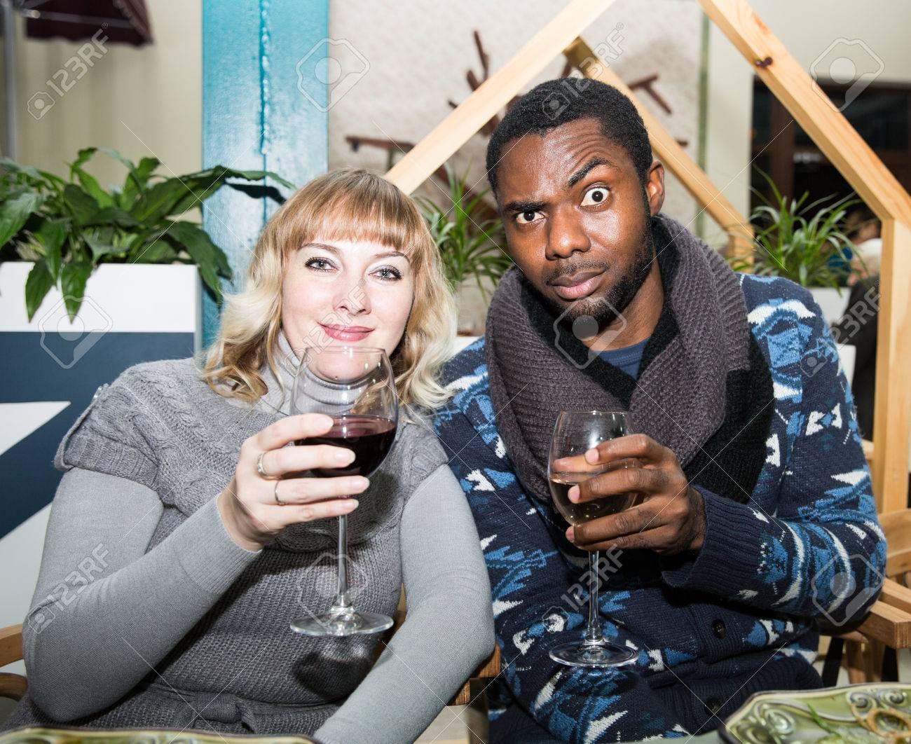 29405959 portrait of happy couple black man and white woman with glass of wine at party