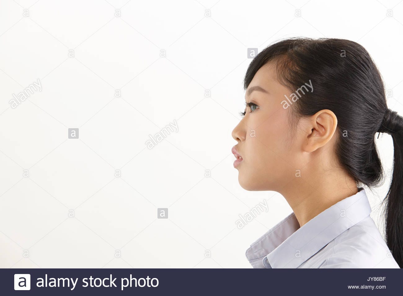 Side view of the asian woman on the white background JY86BF