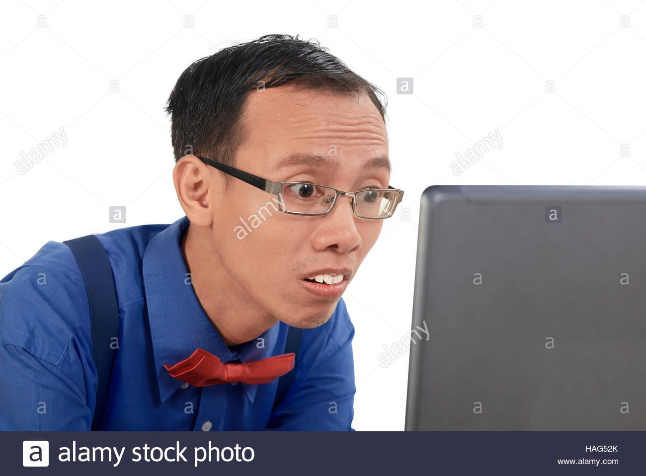 Nerd man using laptop look concentration isolated over white background HAG52K