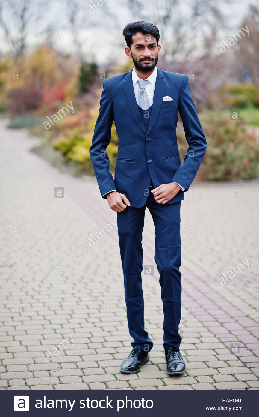 Stylish beard indian man with bindi on forehead wear on blue suit posed outdoor RAF1MT