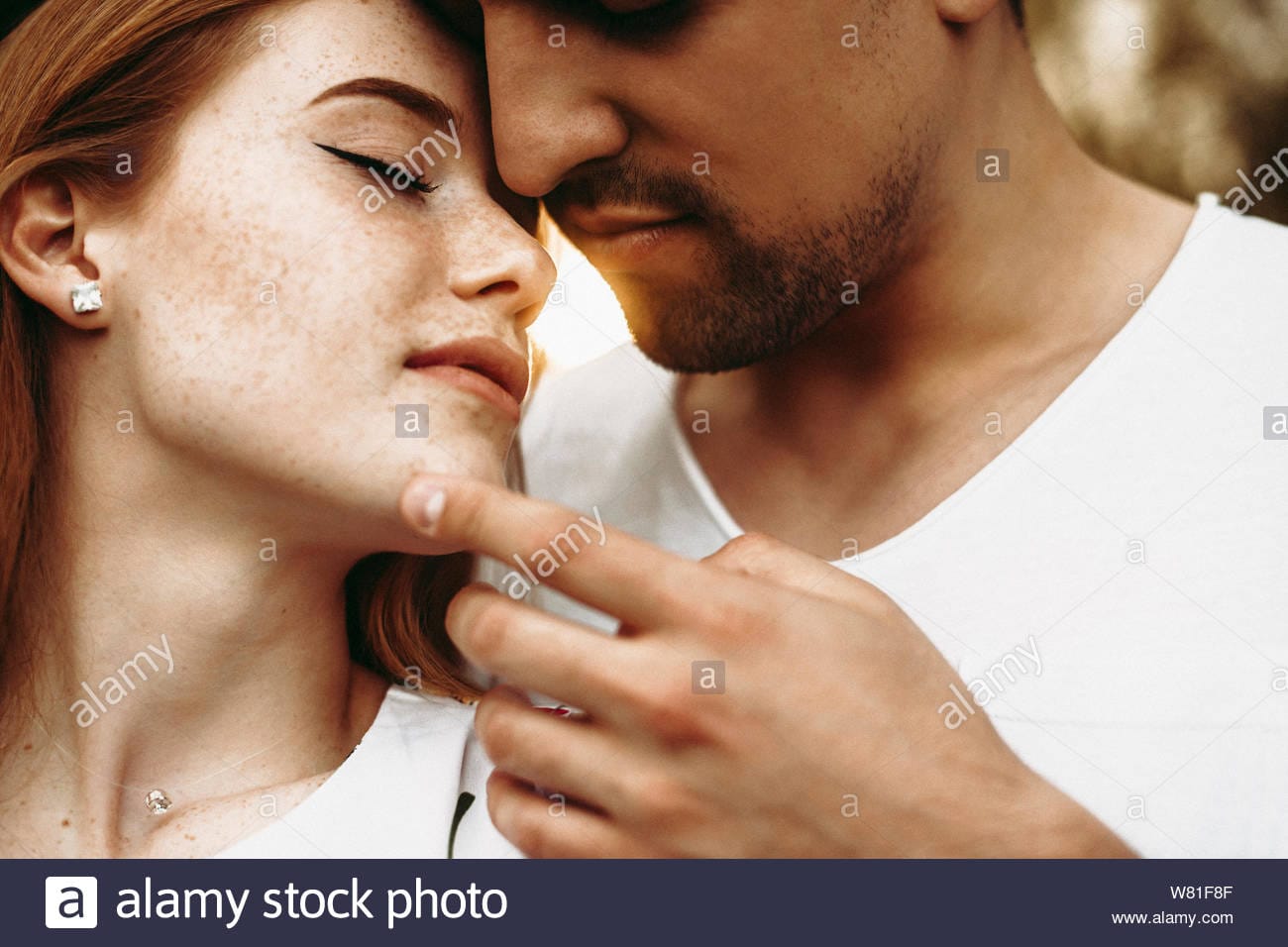 Close up portrait of a beautiful caucasian couple kissing closely with closed eyes while man i
