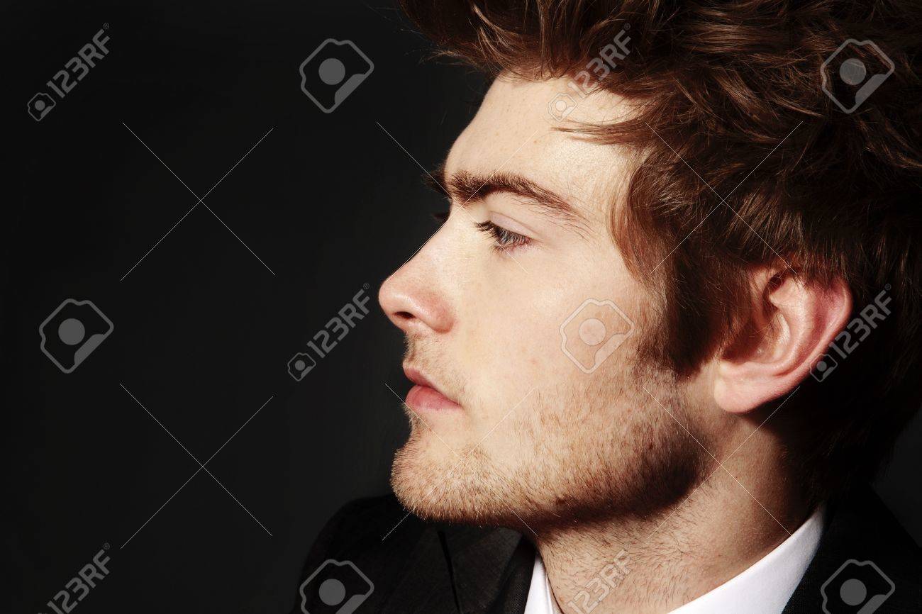 12503354 low key image of side profile of a young man