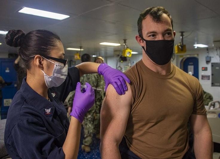 Man getting vaccinated us navy