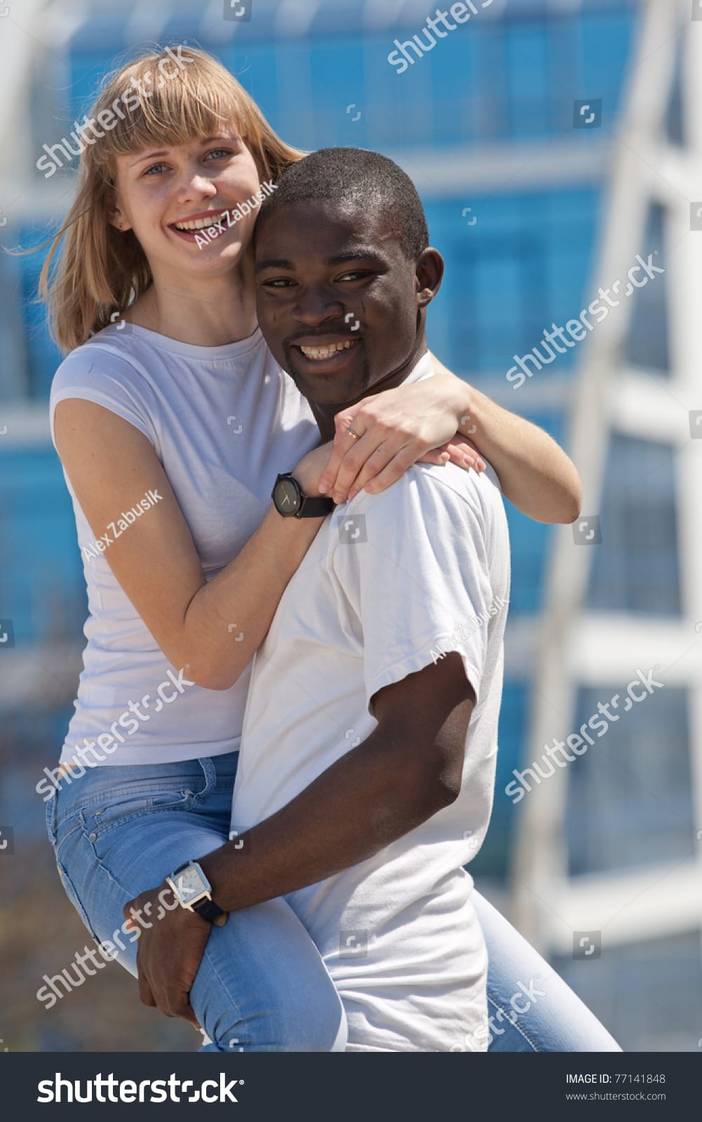 Stock photo white girl and black guy outdoors young man and woman dancing against hotel 77141848