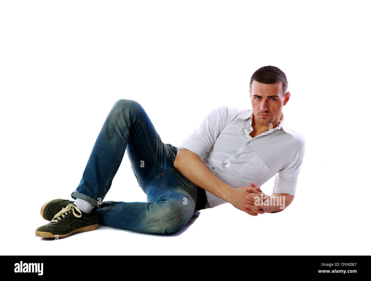 Confident man laying on the floor over white background DYHD87