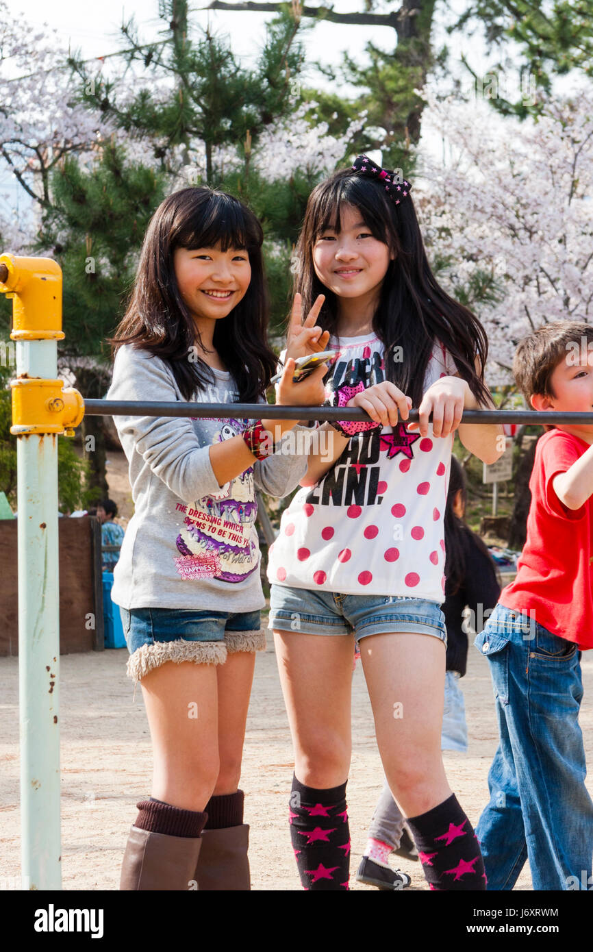 Two young teenage japanese girls 12 13 years old in t shirts and cut J6XRWM