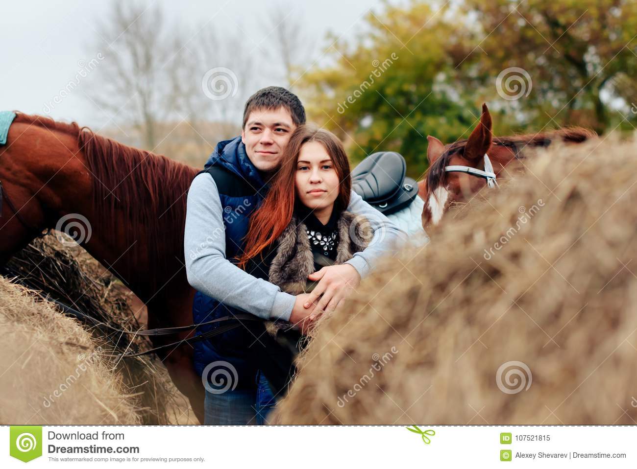 Young couple russian village horses riding 107521815