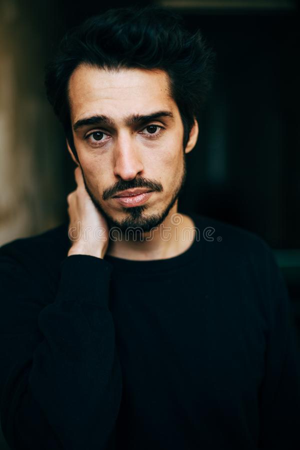 Sad depressed mediterranean looking young man beard dark hair 111668820