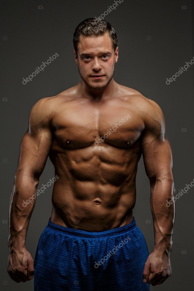 Depositphotos 75400861 stock photo muscular guy in blue shirts