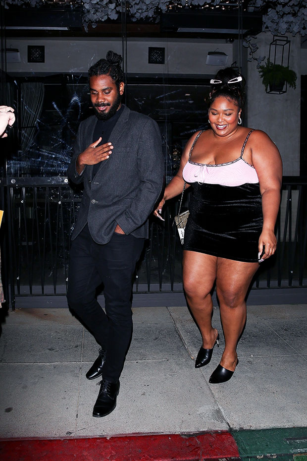 Lizzo in velvet mini dress with mystery man backgrid embed