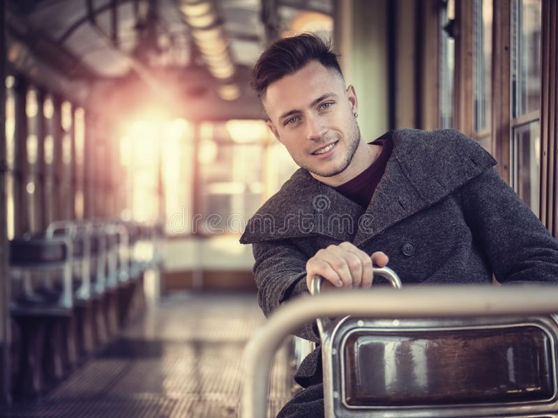 Young man riding tram old bus city handsome empty wearing winter clothes sitting 135574950