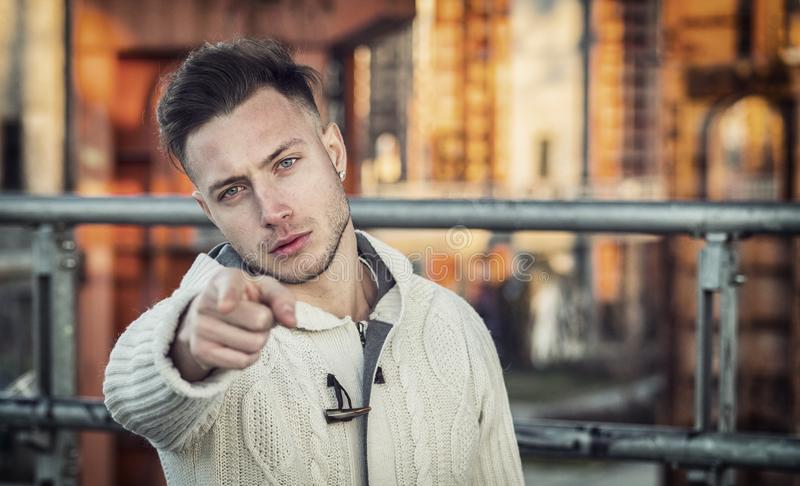Handsome young man pointing fingers you towards camera confident look handsome young man point