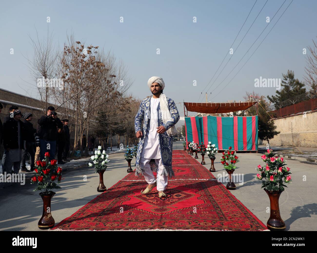 An afghan model presents a traditional costume during the first street fashion show in kabul a