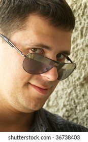 Young man staring over sunglasses 260nw 36738403