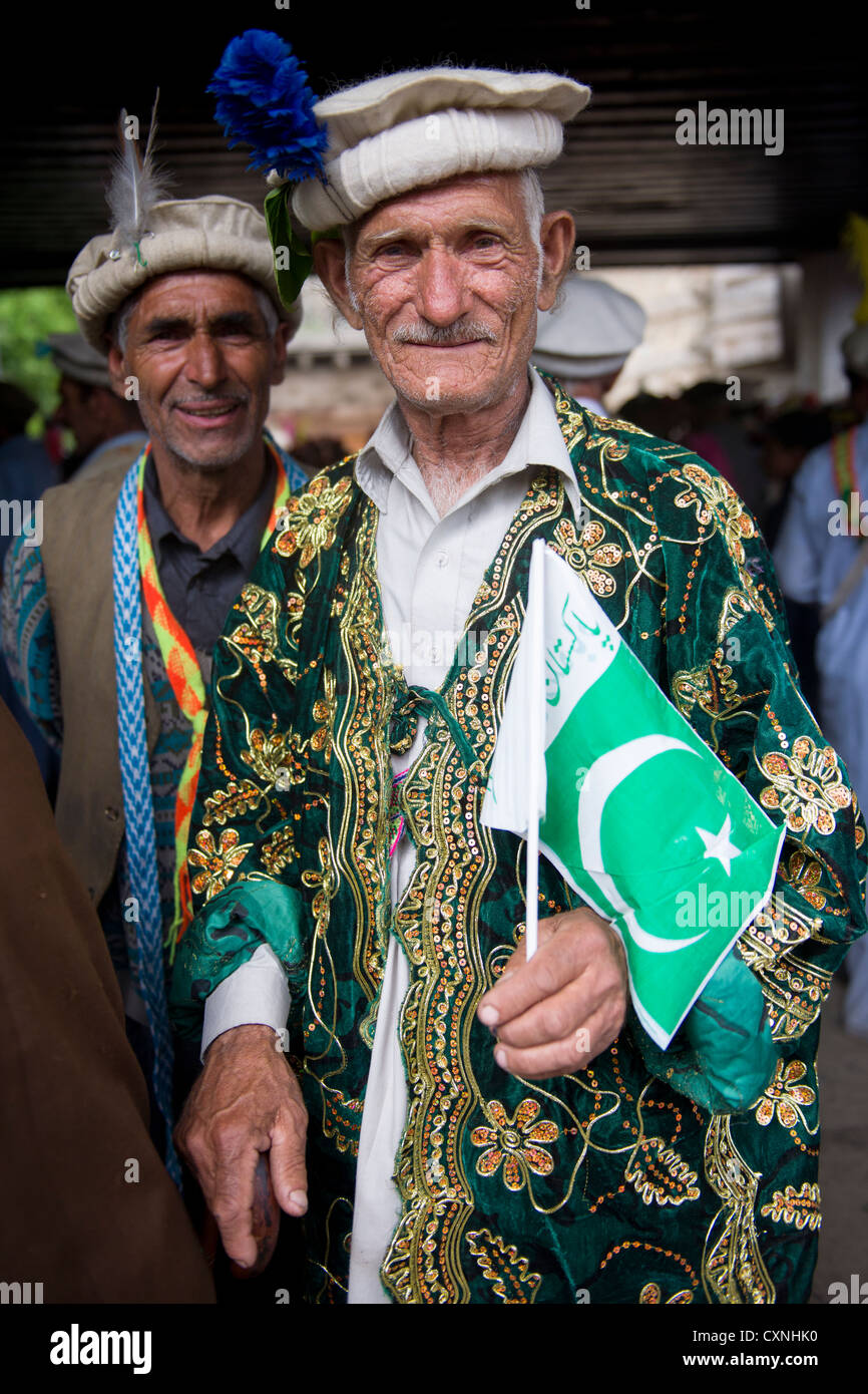 Elder kalash man wearing a traditional cap and carrying a pakistan CXNHK0