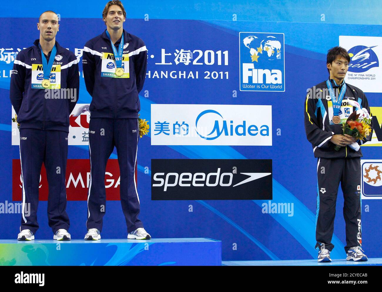 Gold medalists camille lacourt r jeremy stravius l of france and bronze medalist irie ryosuke 