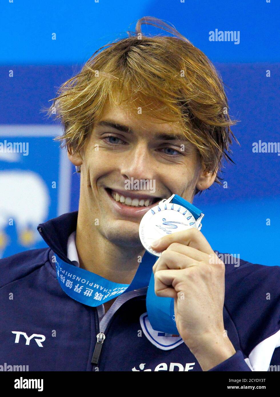 Silver medallist camille lacourt of france displays his medal during a ceremony after the mens