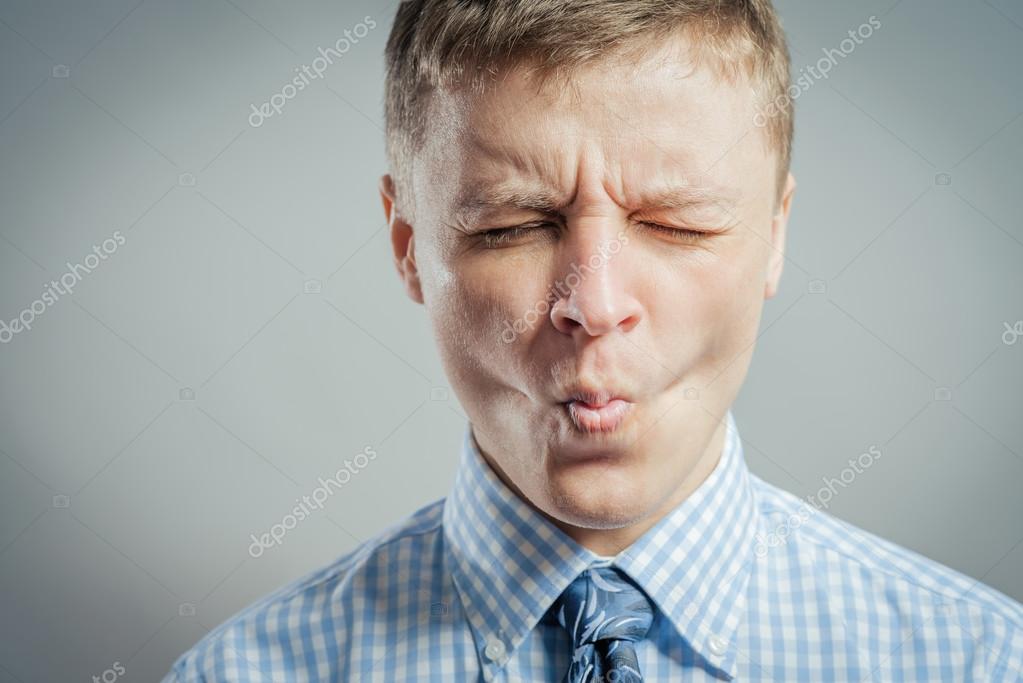 Depositphotos 114075554 stock photo man sucking in his cheeks