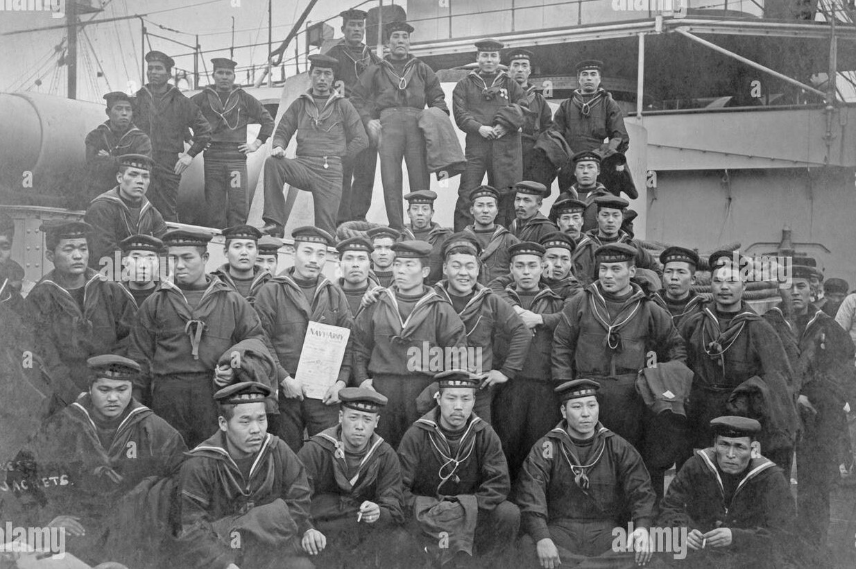 Members of the crew of a japanese warship posing for a group photo on deck of the ship 2B2B8N9