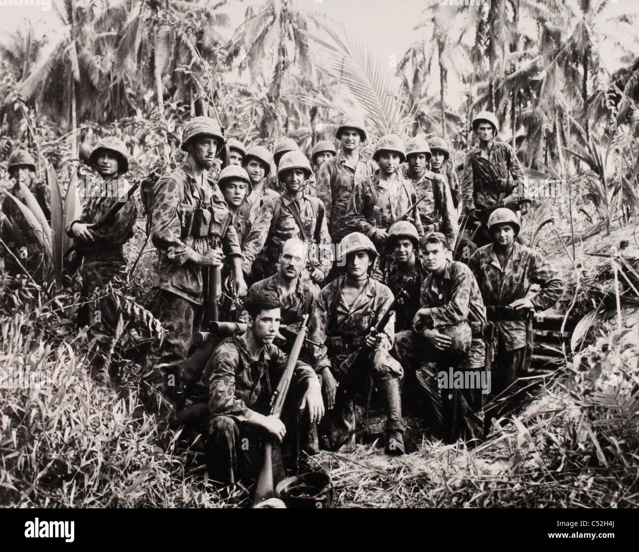 A group of united states marine raiders pose for photo in front of C52H4J